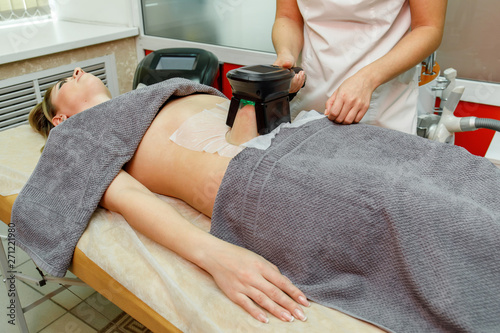 Beauty therapist applying cryolipolysis treatment. Non-surgical fat reduction photo