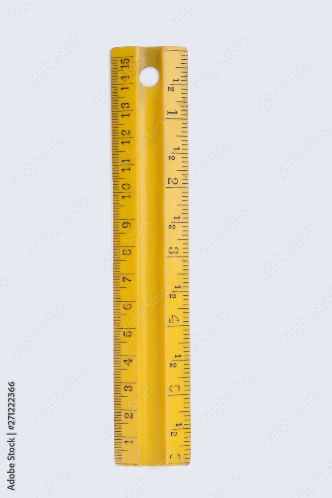 Yellow plastic ruler isolated on white background. Measuring instrument, vertical image. Yellow plastic ruler isolated on white background. Measuring instrument, vertical image.