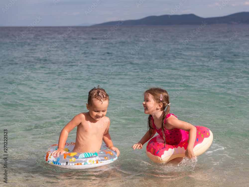 happy children having fun and swimming in the sea, Adriatic coast, Croatia