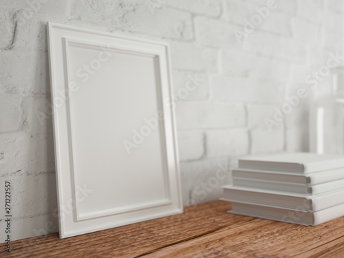 Empty frame on wooden table with books. Bricks wall. Mock up. Rendering made using free software Blender
