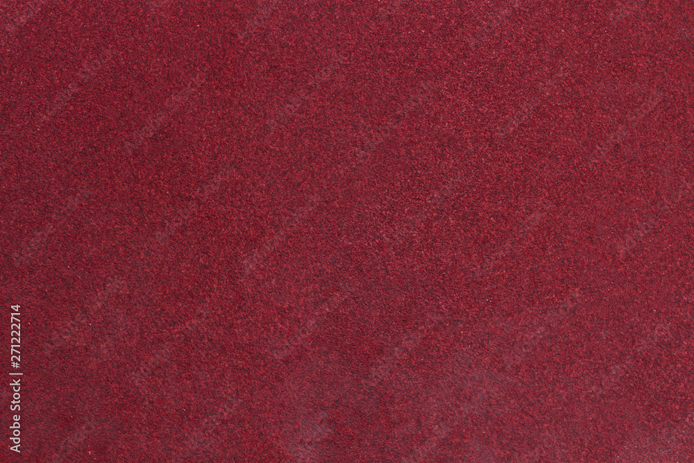 Fototapeta premium Red rough textured sandpaper background. Macro red sandpaper.