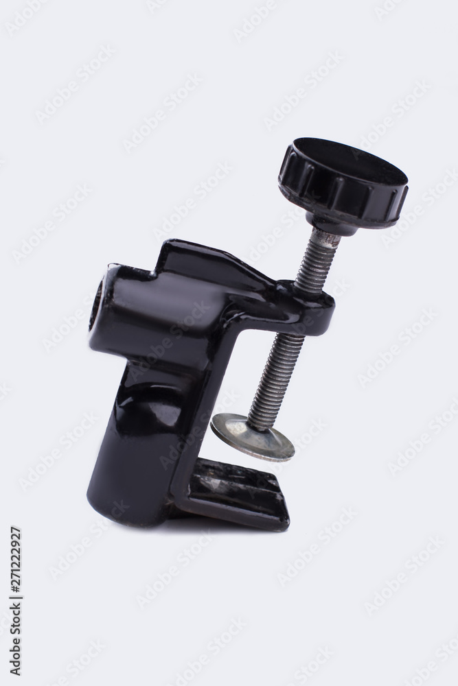 Industrial c-clamp on white background. Black iron c- clamp isolated on white background. Vertical image.