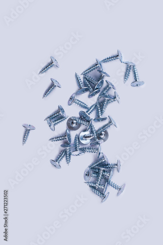 Screw nails on white background, top view. Equipment for technician. © DenisProduction.com