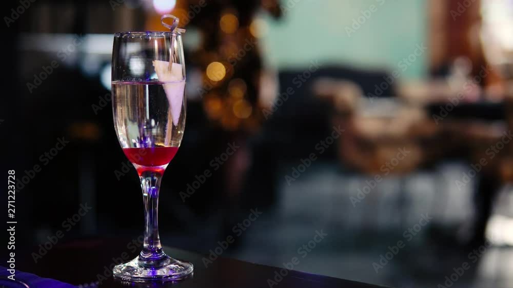 Blurred image of the interior of the restaurant. Defocused people with different activities. A glass of wine in the foreground. Blurred image of the interior of the restaurant. Defocused people with different activities. A glass of wine in the foreground.