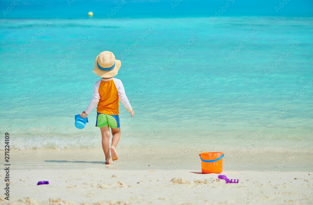Three year old toddler playing on beach Three year old toddler playing on beach