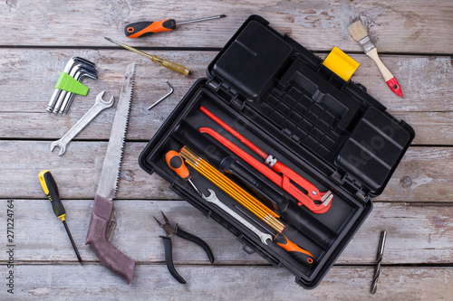 Set of construction tools on wooden background. Box set of metal working tools on wooden background. Construction industry concept.