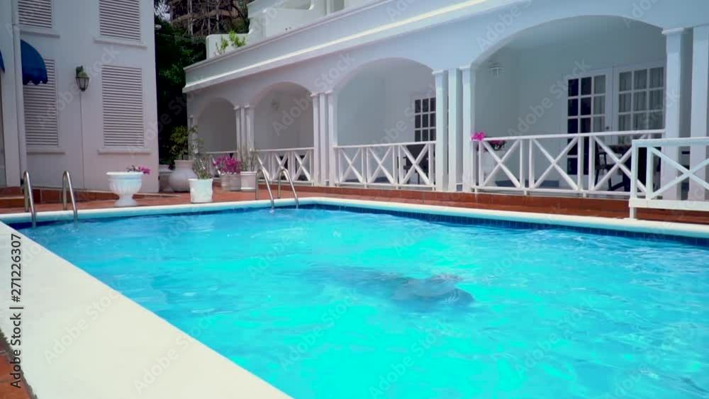 Silhouette of a man under water in the pool Silhouette of a man under water in the pool