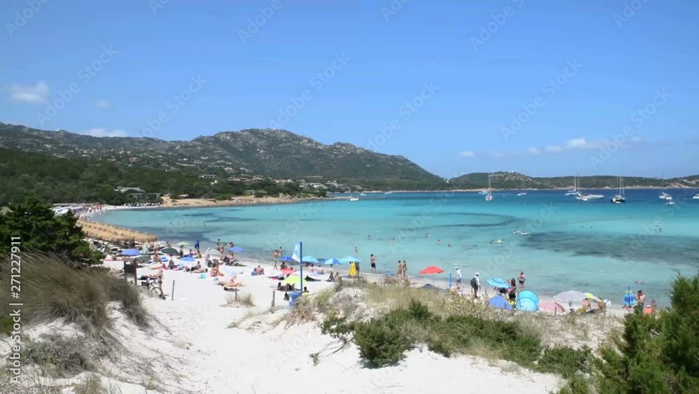 A panoramic view of people relaxing on a beach in the Mediterranean sea A panoramic view of people relaxing on a beach in the Mediterranean sea