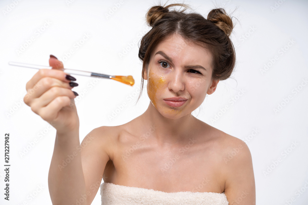 a young girl puts on a face mask for the first time in her life. Can not. Bad skin of the face. Acne on the face. Natural, no makeup. European 25 years old, white a young girl puts on a face mask for the first time in her life. Can not. Bad skin of the face. Acne on the face. Natural, no makeup. European 25 years old, white