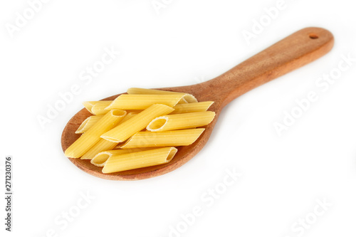 dry pasta penne Italian food in a spoon on white background.