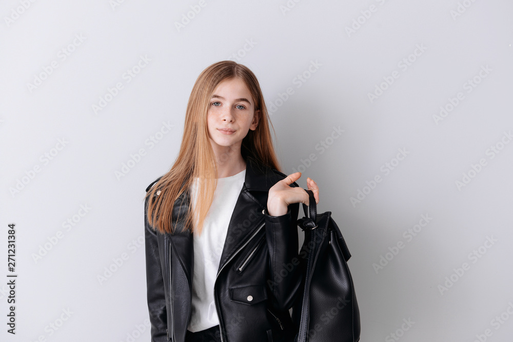 Stylish teenage girl on light background Stylish teenage girl on light background