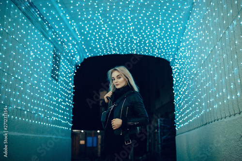 beauty woman posing over night illuminated street
