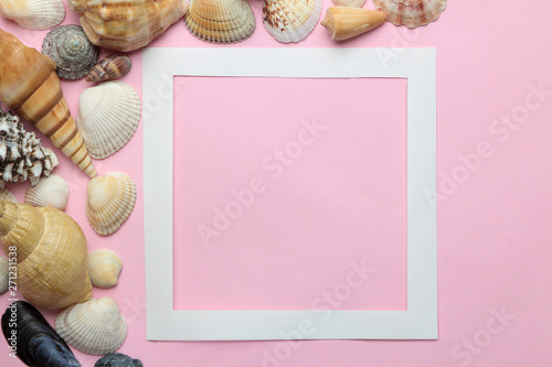 Summer frame. Paper frame for your text and seashells on a gentle pink background. top view