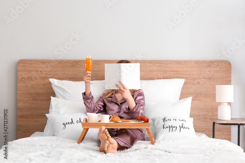 Woman reading book while ha...