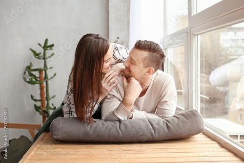 Happy couple resting near w...