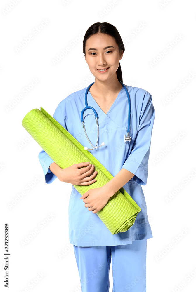 Portrait of young Asian physiotherapist with mat on white background Portrait of young Asian physiotherapist with mat on white background