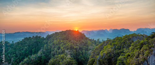 Fototapeta Naklejka Na Ścianę i Meble -  Panorama of tropicall landscape with dramatic sunset and steep mountain ridge on horizon. Krabi, Thailand