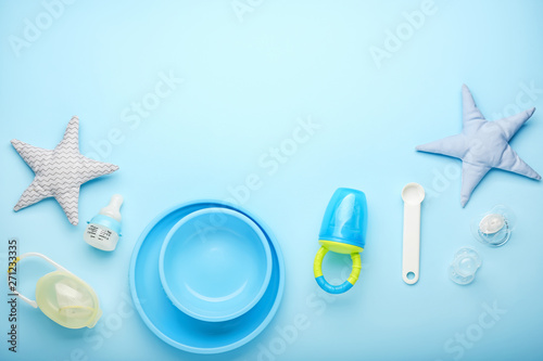 Baby nibbler with accessories on color background photo