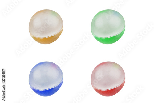 Set of four different color yellow, green, red, blue pills healthy or narcotic in form of ball isolated on white background