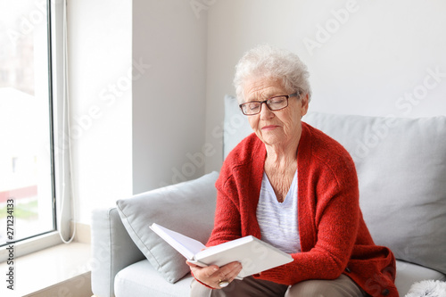 Senior woman reading book a...