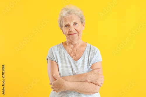 Portrait of senior woman on color background photo