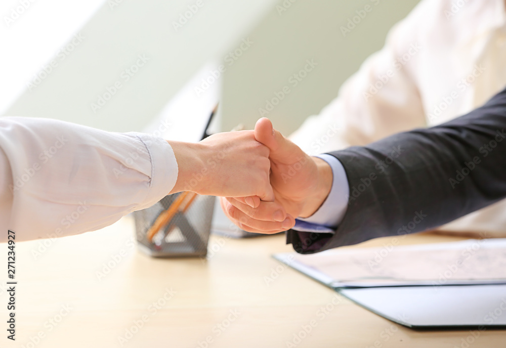 Human resources manager shaking hands with applicant after successful interview