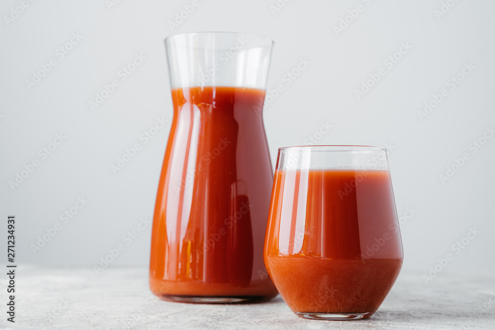Red tomato juice in glass isolated over white background. Vegetable smoothie. Organic beverage. Horizontal shot. Healthy vitaminized drink Red tomato juice in glass isolated over white background. Vegetable smoothie. Organic beverage. Horizontal shot. Healthy vitaminized drink