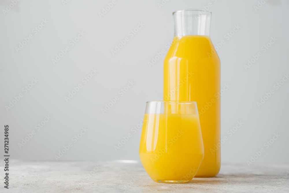 Horizontal shot of freshly squeezed orange juice made of citrus in glass containers, isolated over white background with blank space Horizontal shot of freshly squeezed orange juice made of citrus in glass containers, isolated over white background with blank space