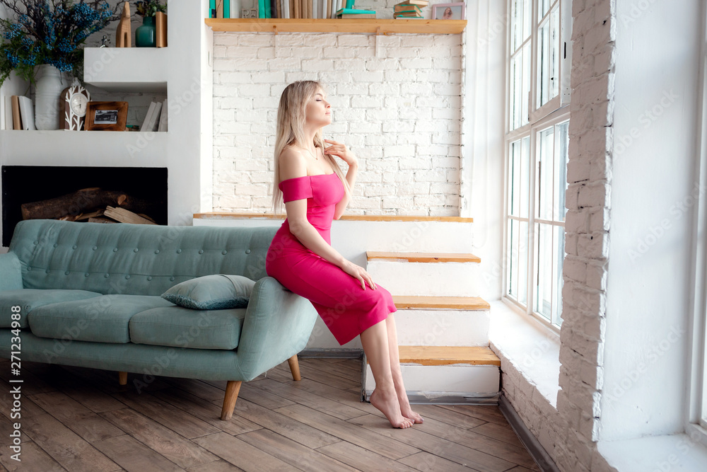 Young woman is sitting on a couch Young woman is sitting on a couch