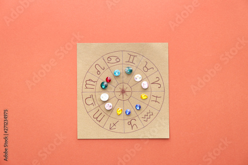 Photos Astrological horoscope with birthstones on color background