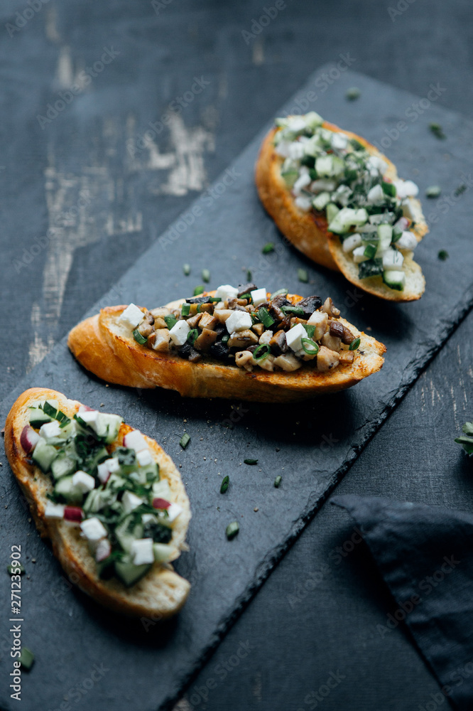 Different bruschetta on black board Different bruschetta on black board