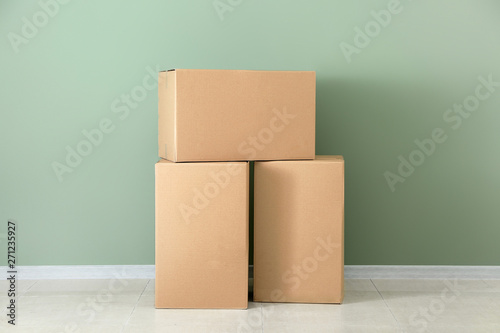 Cardboard boxes near color wall