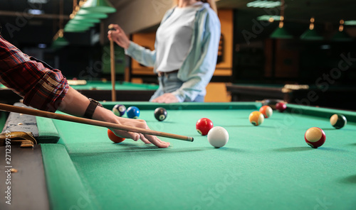 Fotografía Young women playing billiard in club