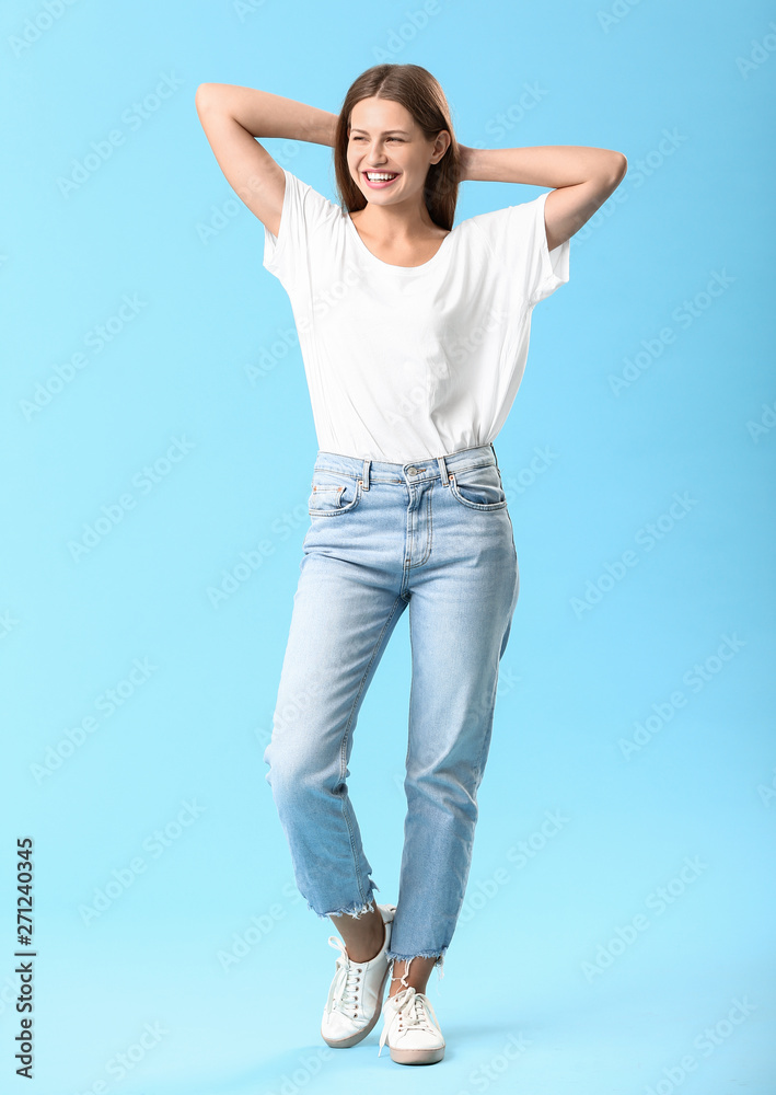 Stylish young woman in jeans on color background Stylish young woman in jeans on color background