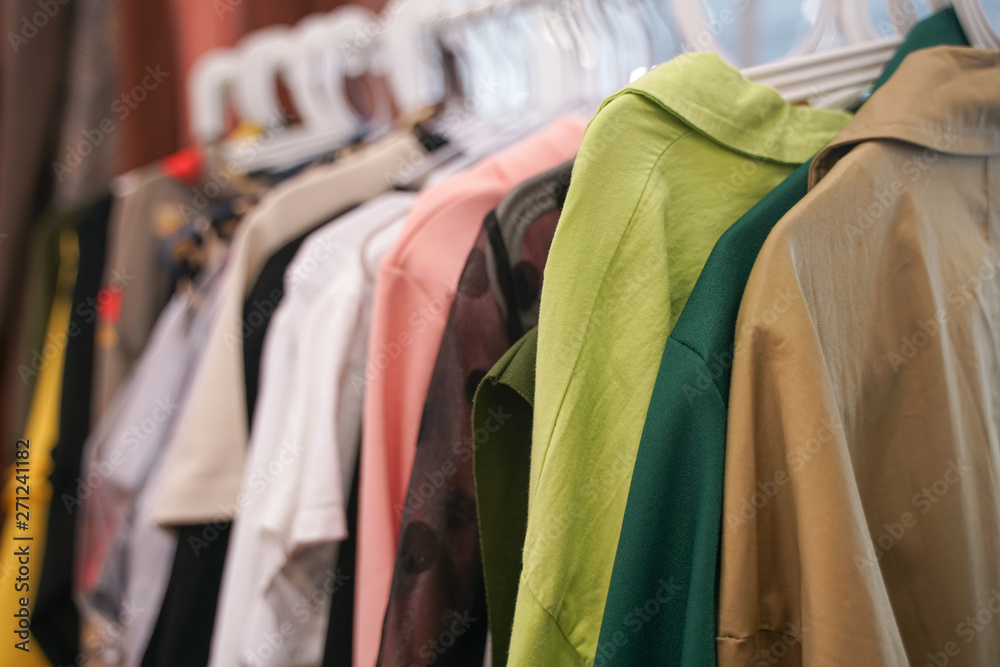 fashion stylish clothes hanging on hangers in the store. nobody. fashion stylish clothes hanging on hangers in the store. nobody.