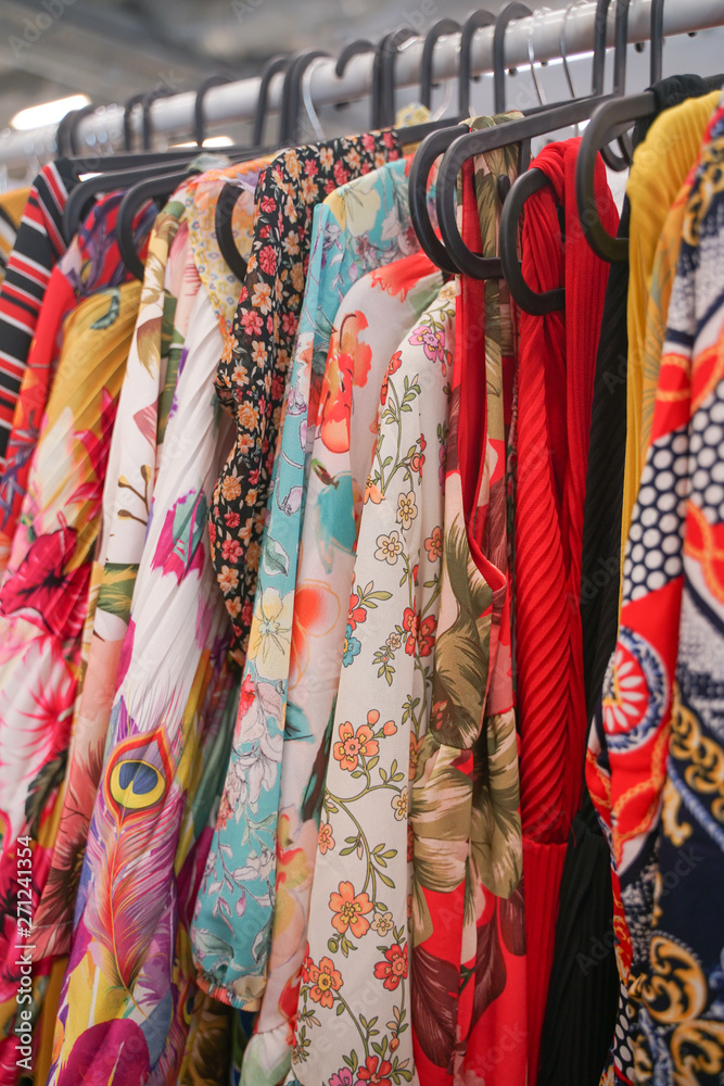 fashionable clothes hanging on hangers in the store. nobody.