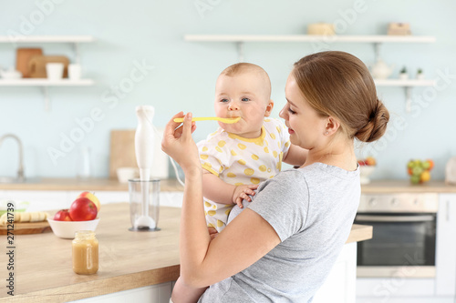 Mother feeding her little b...