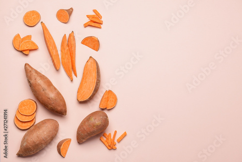 Fresh sweet potatoes on light background