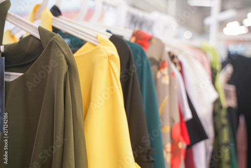 fashionable clothes hanging on hangers in the store. nobody.