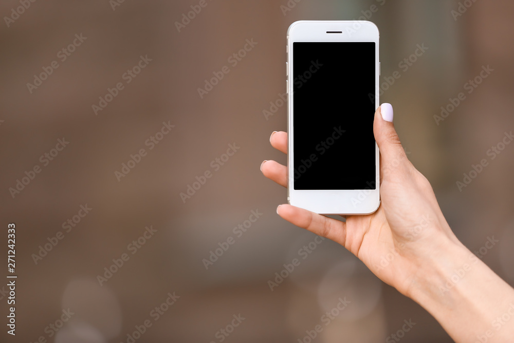 Young woman with mobile phone outdoors Young woman with mobile phone outdoors