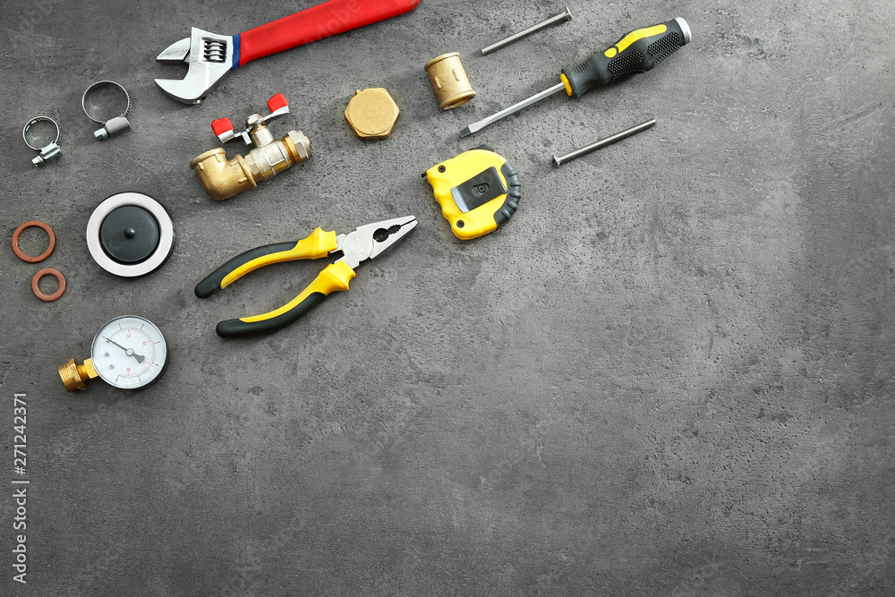 Set of plumber tools on grunge background