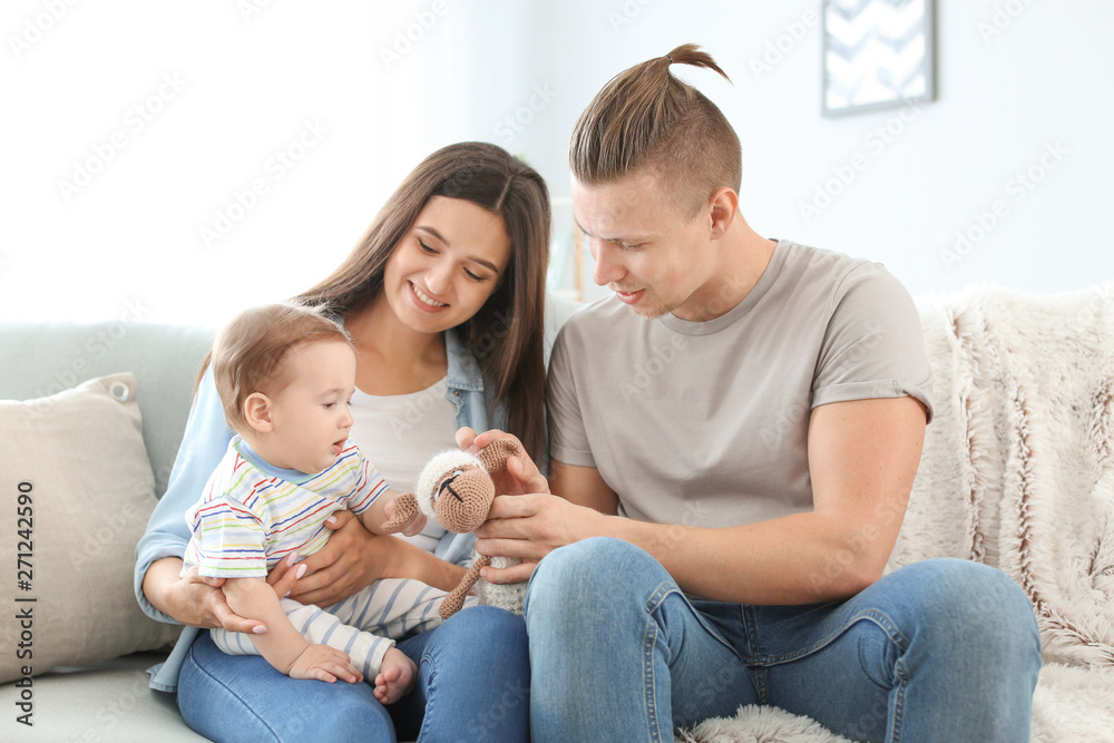 Happy parents with cute little baby at home