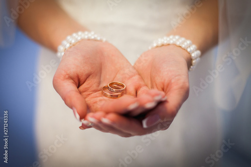 Wedding rings in hands of the bride. the girl offers to marry. marry me. wedding rings in the palms of the bride