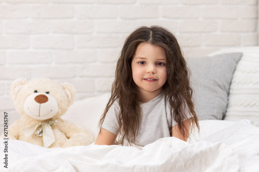 adorable happy little child girl with teddy bear in bed in morning. adorable happy little child girl with teddy bear in bed in morning.