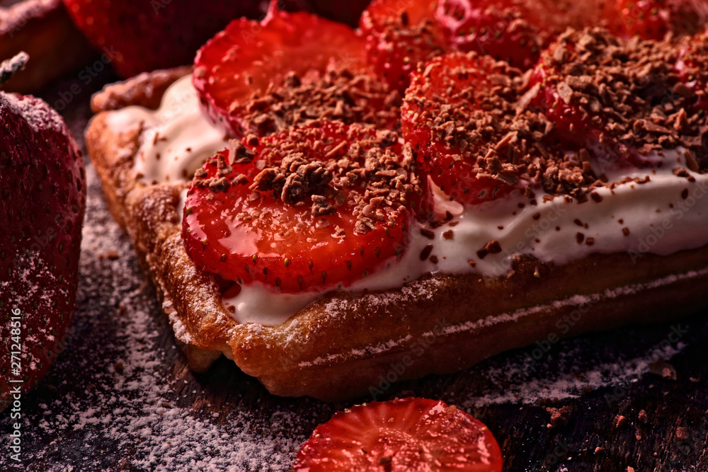 Obraz premium delicious crispy waffles with chocolate sprinkles and strawberries