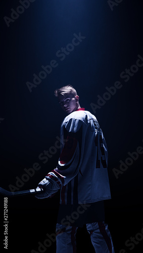 Hockey player isolated in black background wait start
