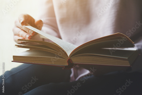 woman reading book, turning pages