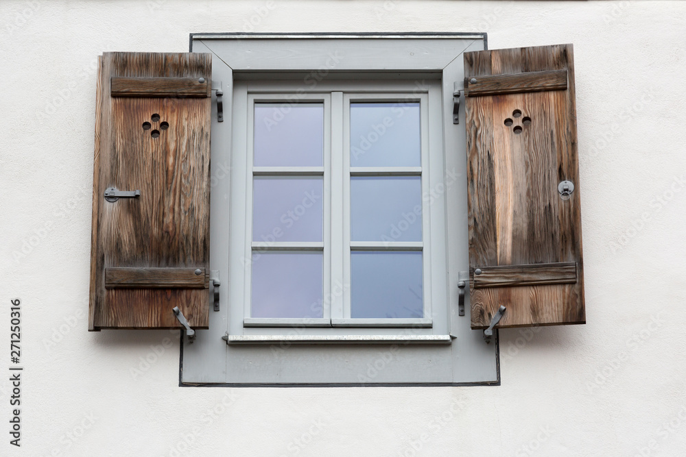 Window shutters on gray wall, Burano, Venice Window shutters on gray wall, Burano, Venice