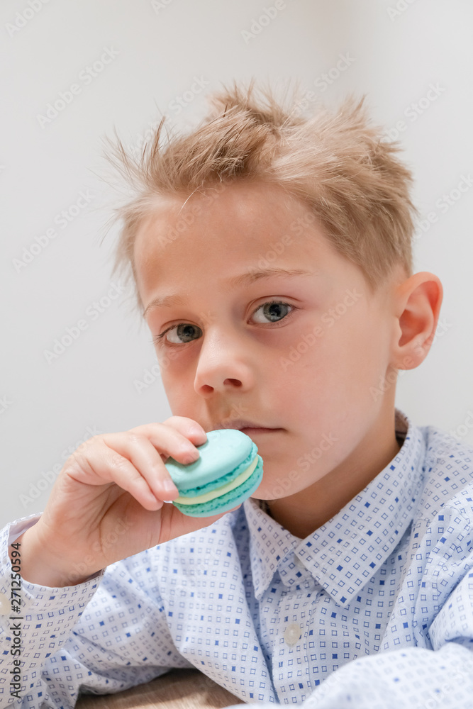 caucasian child snacking with a blue cookie caucasian child snacking with a blue cookie