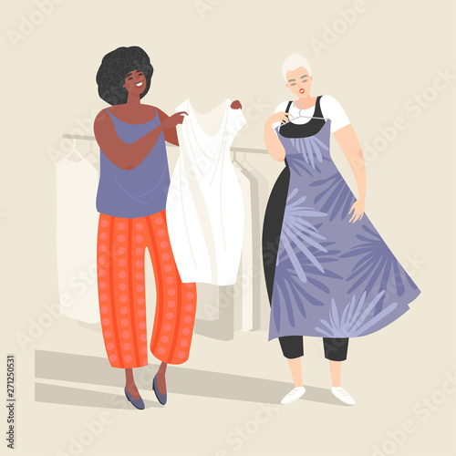 Two lovely young women choose dresses in the women's clothing department